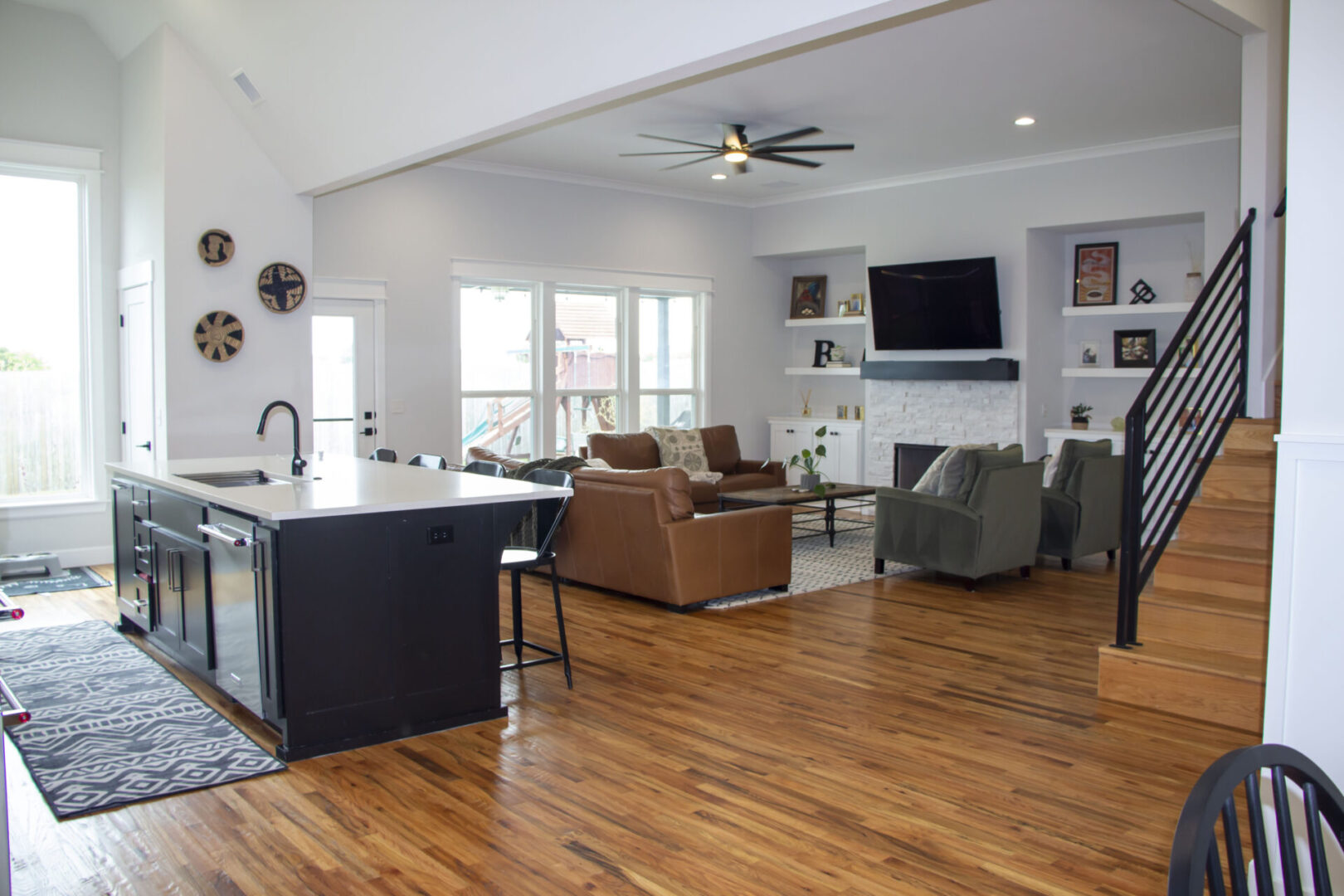 A living room with hard wood floors and furniture.