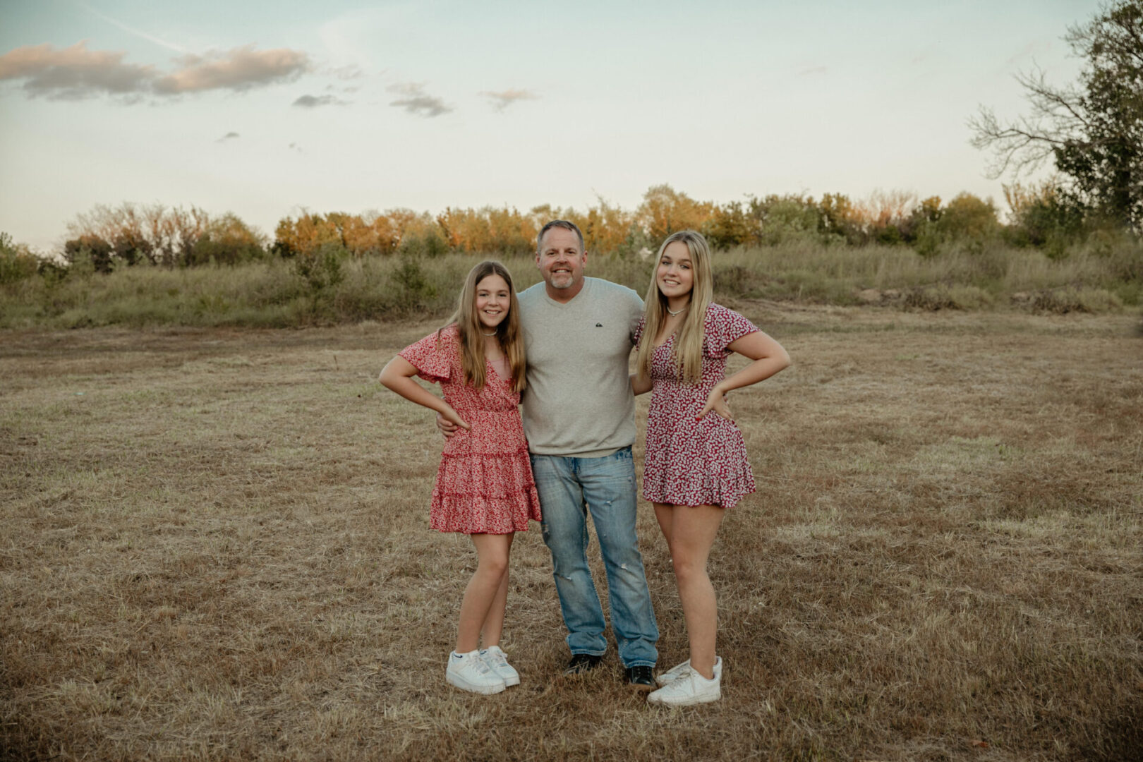 A man and two women posing for a picture.