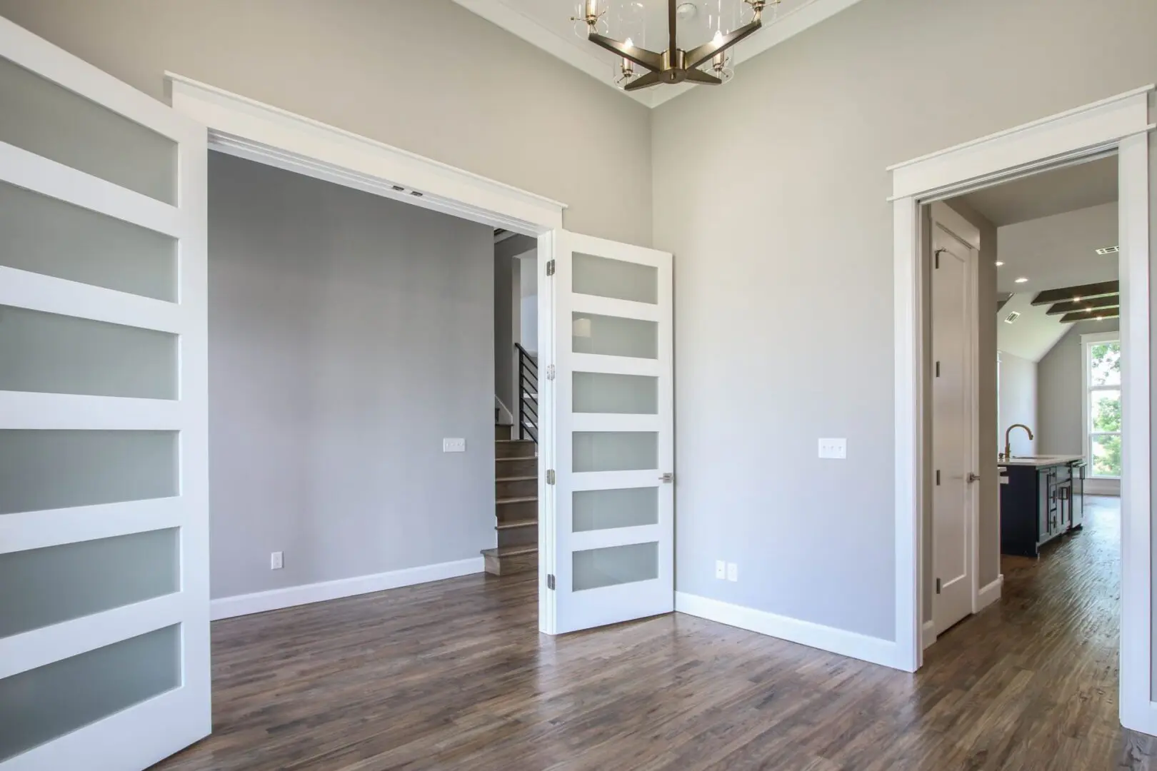 A room with a door open and a light fixture.