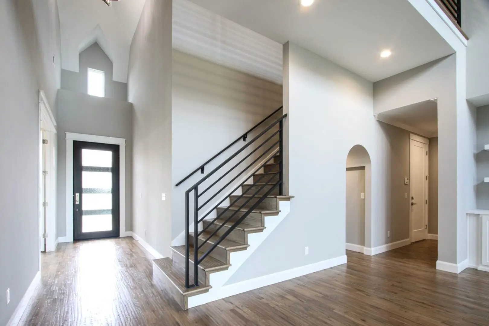 A large open floor plan with stairs leading to the second story.