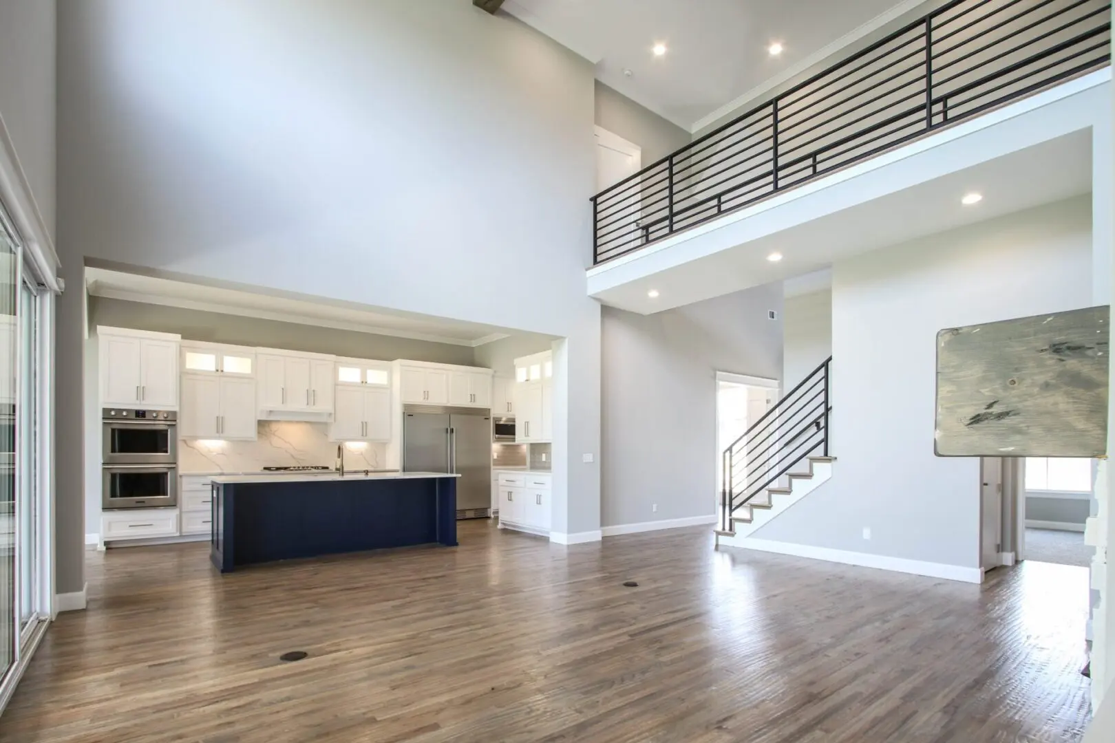 A large open floor plan with a kitchen and living room.