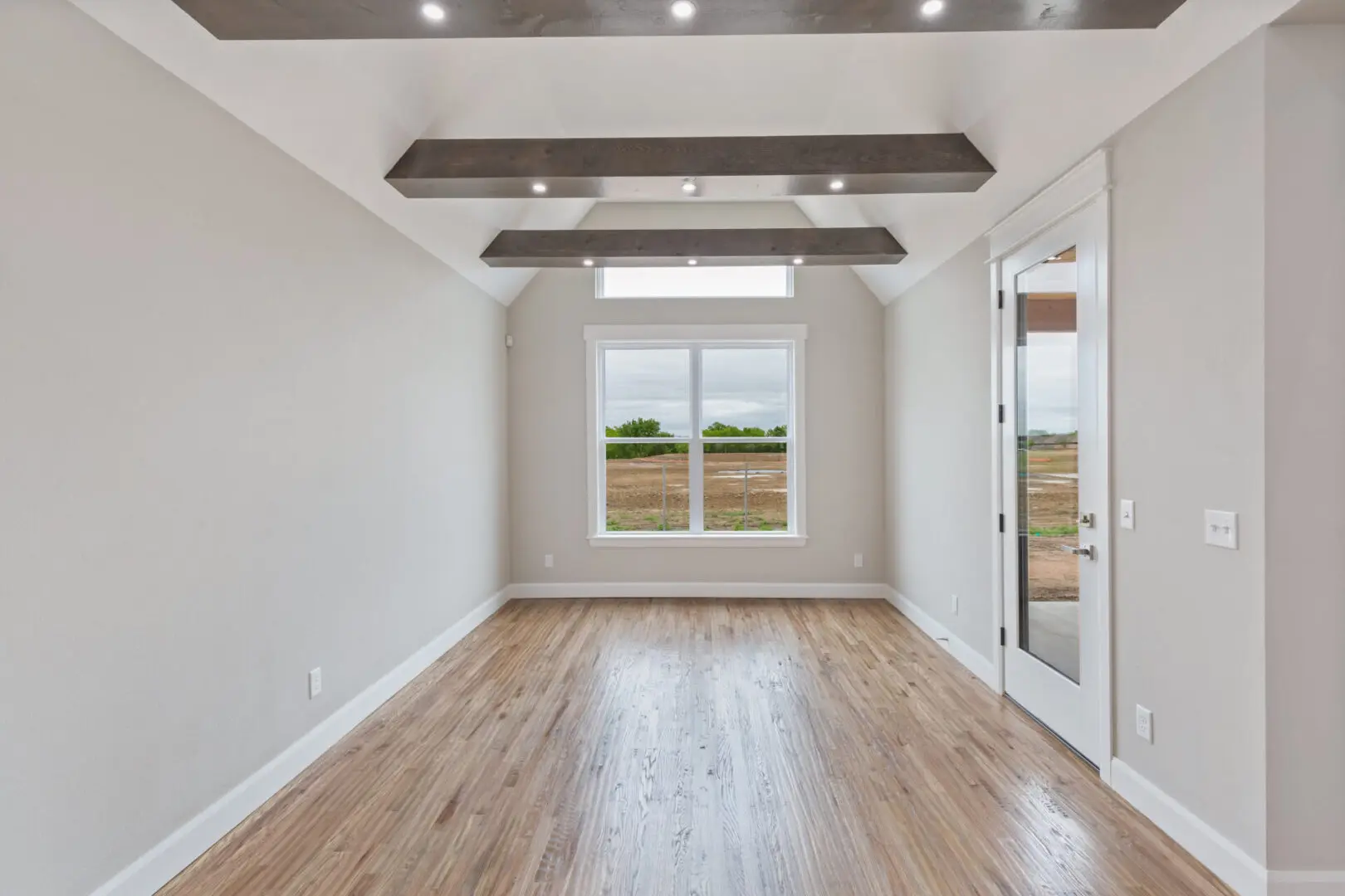 A room with wood floors and white walls.