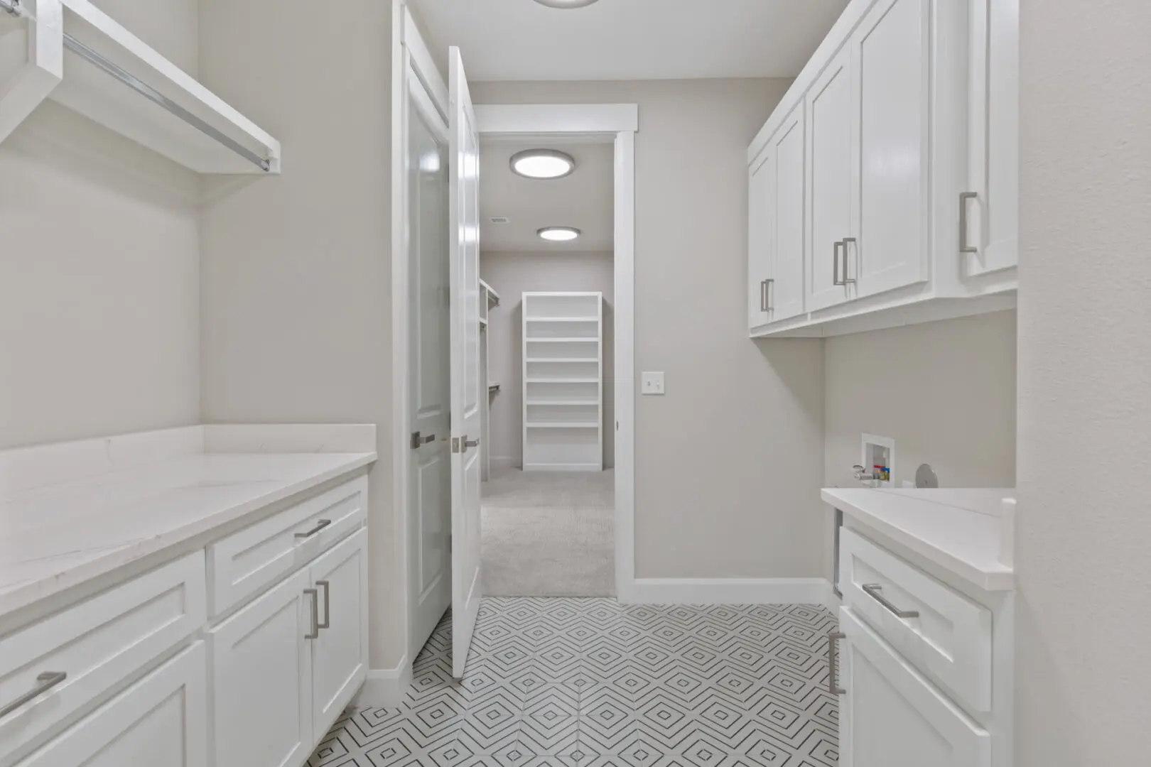 A white kitchen with an open door and a walk in shower.