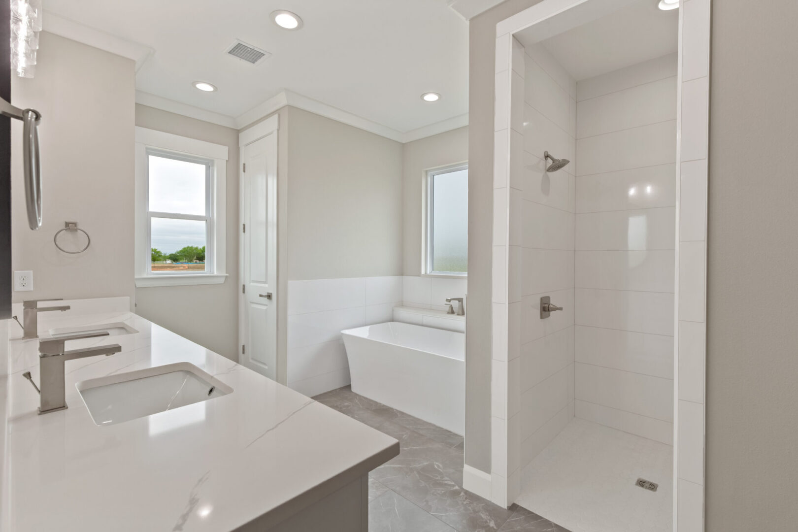 A bathroom with white walls and tile floors.