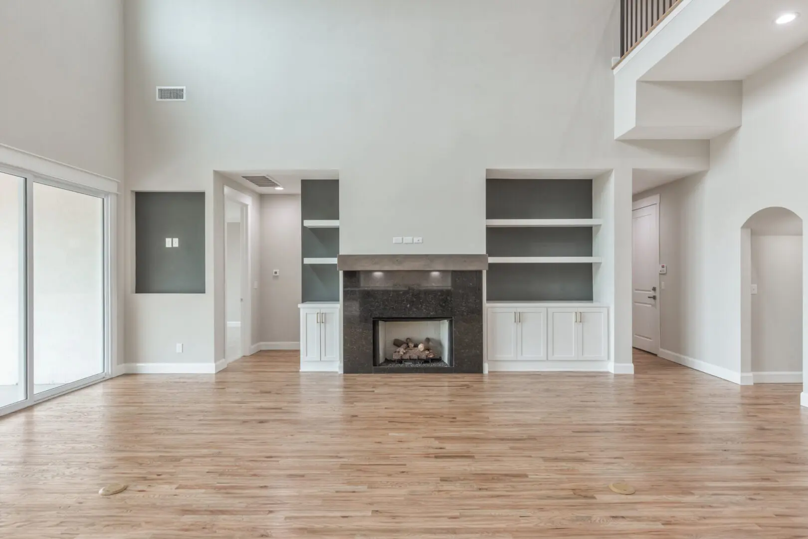 A room with wood floors and white walls.