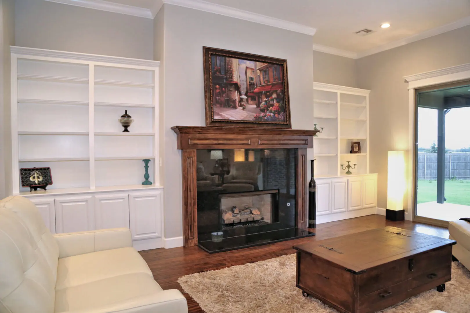 A living room with a fireplace and bookcases