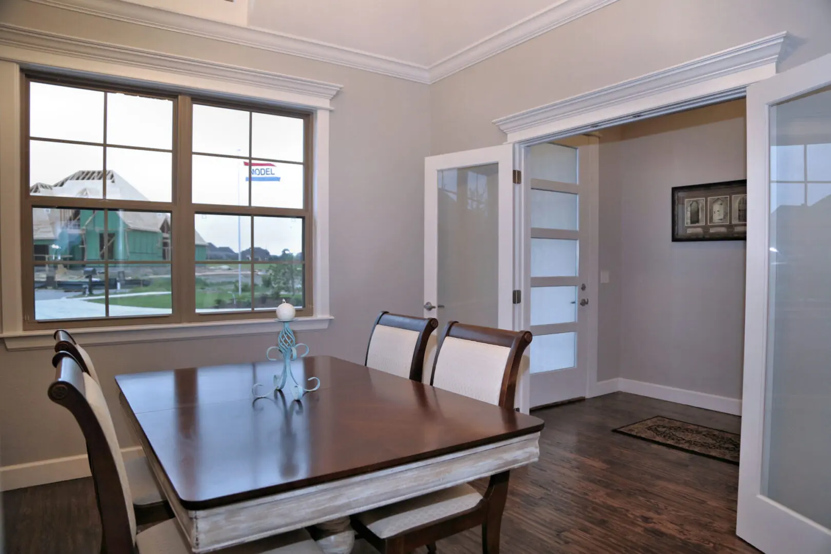 A dining room table with chairs and a window.