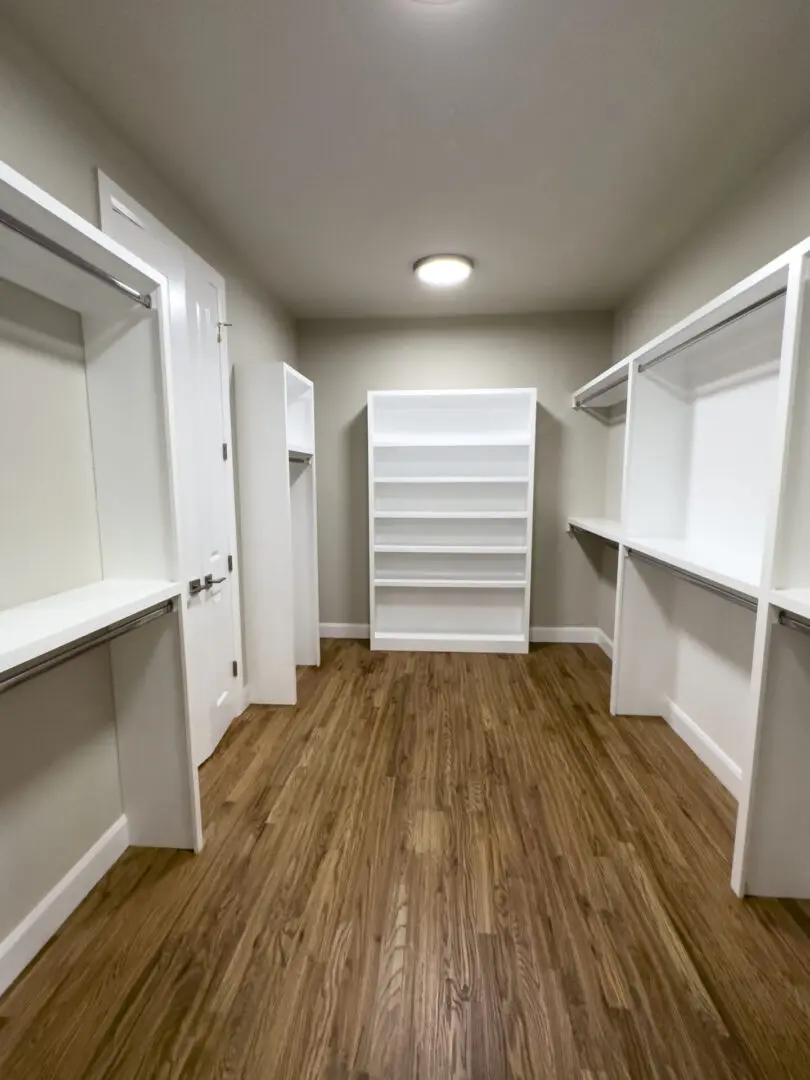 A room with many shelves and a closet