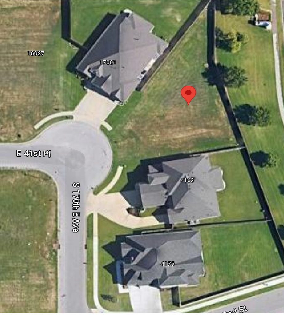 A red dot is shown on the ground near some houses.