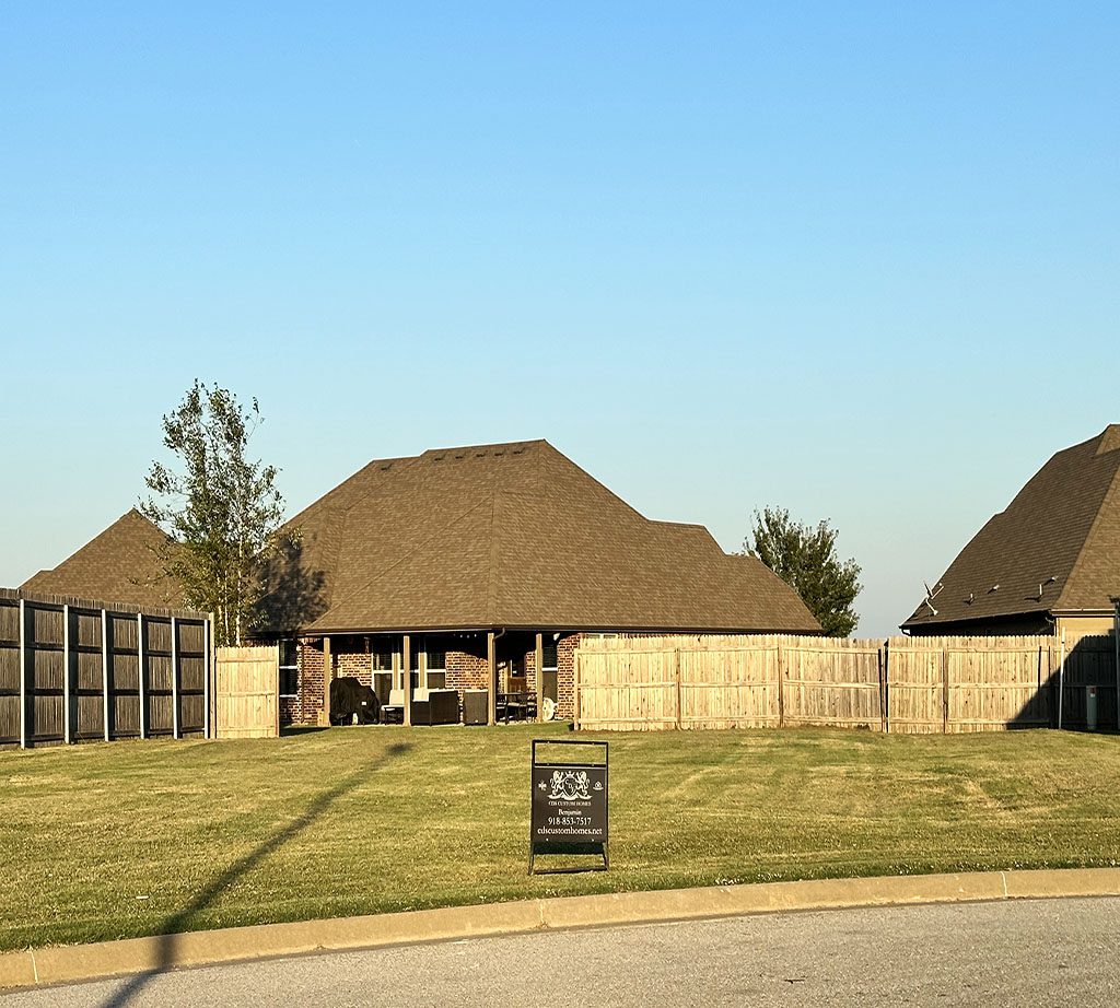 A row of houses with grass in front.