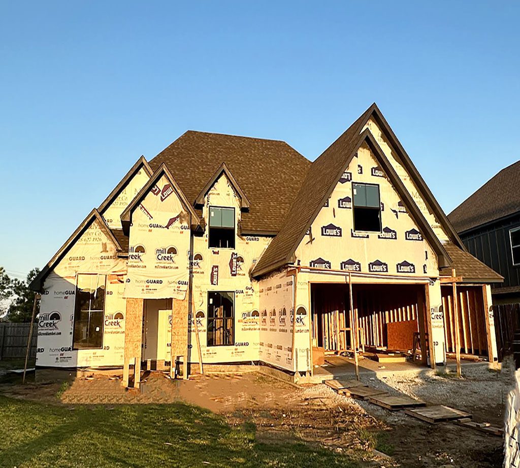 A house under construction with the roof up.